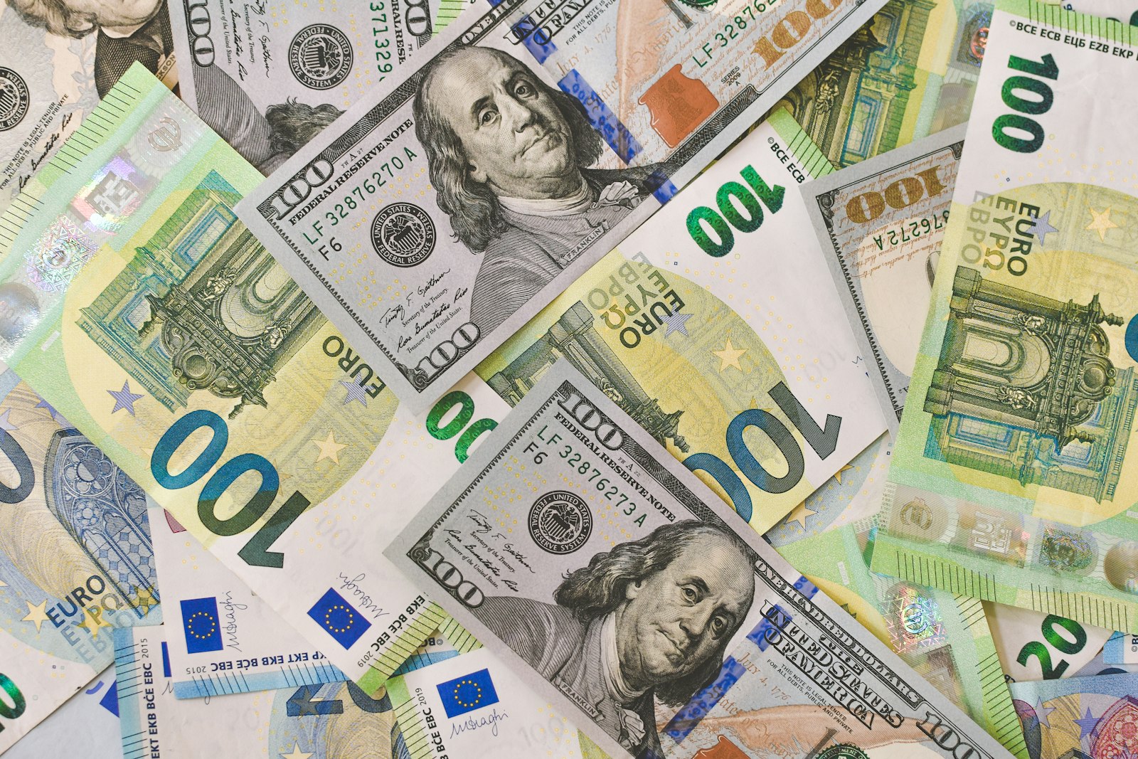 A pile of euro and US dollar banknotes in various denominations